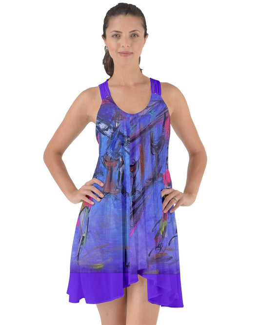A captivating purple swirling dress featuring criss-cross back straps, adorned with original art by Leeorah. The fabric gracefully flows, accentuating movement with its seductive design .Front view